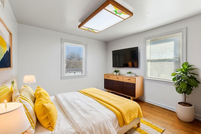 bedroom featuring light wood-style flooring and baseboards