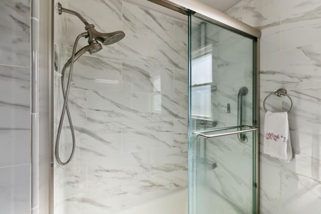 full bathroom featuring a marble finish shower