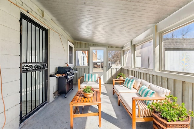 sunroom featuring vaulted ceiling