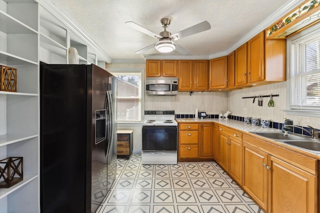 kitchen featuring white range with electric stovetop, open shelves, stainless steel microwave, a sink, and black fridge