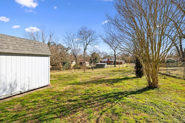 view of yard featuring a storage shed, an outdoor structure, and a fenced backyard