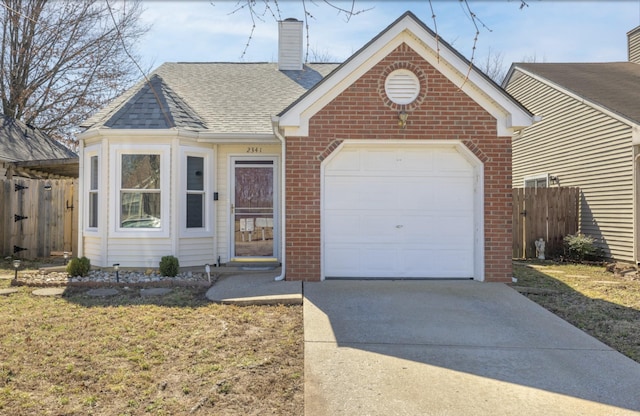 view of front of house with concrete driveway, brick siding, fence, and a chimney