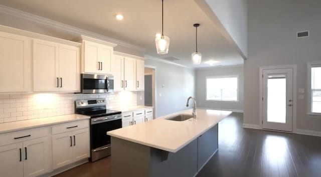 kitchen featuring a sink, visible vents, ornamental molding, appliances with stainless steel finishes, and backsplash