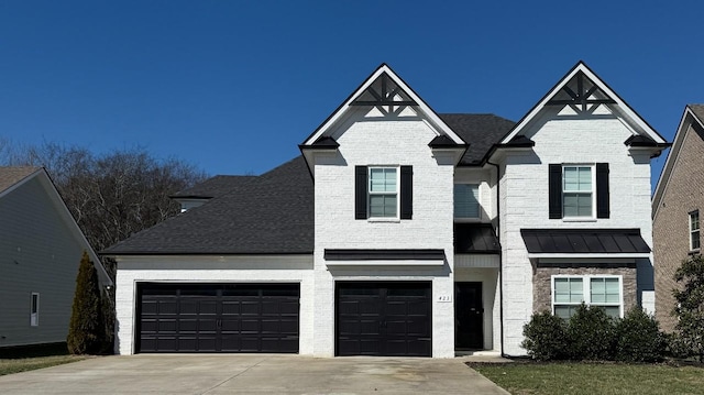 view of front of home with roof with shingles, brick siding, a standing seam roof, metal roof, and driveway