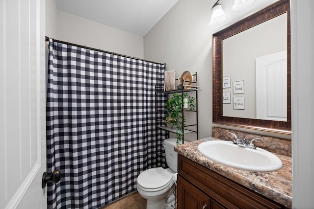 bathroom with curtained shower, vanity, and toilet