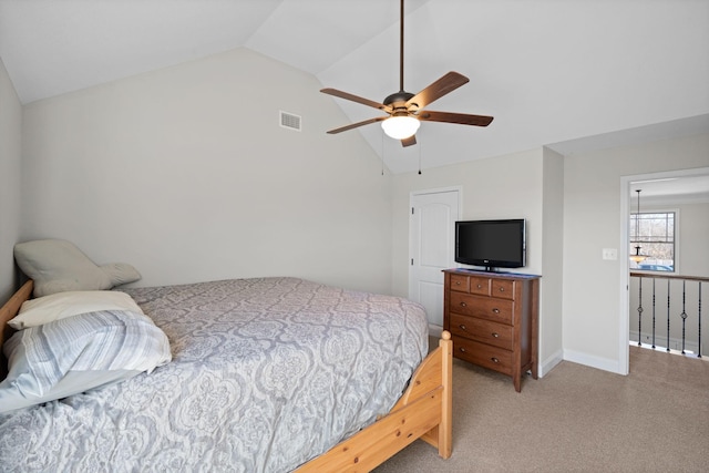 bedroom with light colored carpet, visible vents, a ceiling fan, vaulted ceiling, and baseboards