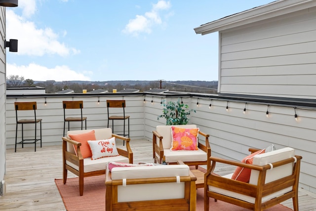 wooden terrace featuring outdoor lounge area