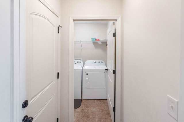 laundry room featuring laundry area, washer and clothes dryer, and light tile patterned flooring