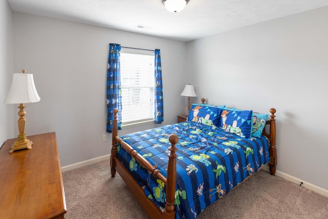 carpeted bedroom with visible vents and baseboards