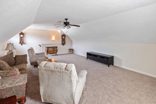 carpeted living area with lofted ceiling, a textured ceiling, baseboards, and a ceiling fan