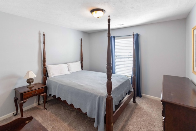 carpeted bedroom with a textured ceiling, visible vents, and baseboards