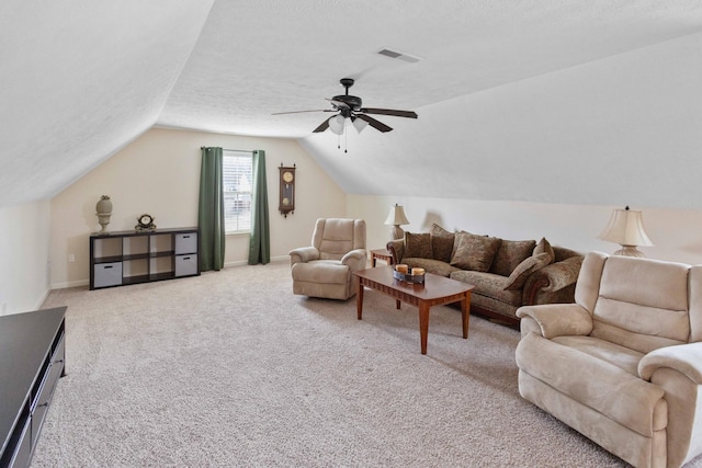 carpeted living room featuring a textured ceiling, a ceiling fan, visible vents, vaulted ceiling, and baseboards