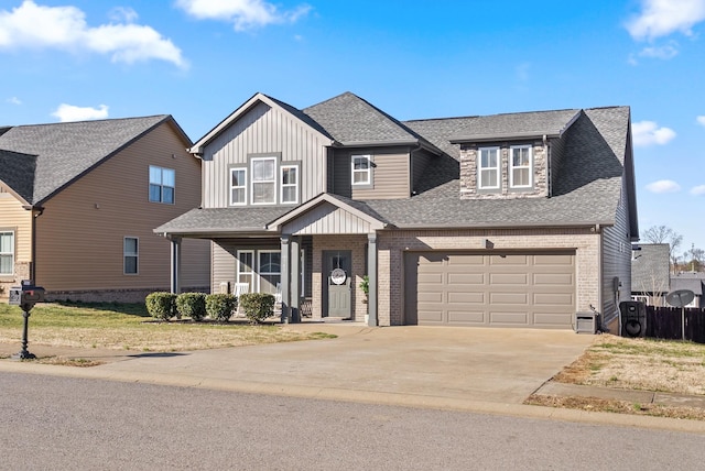 view of front facade featuring board and batten siding, a shingled roof, concrete driveway, and brick siding