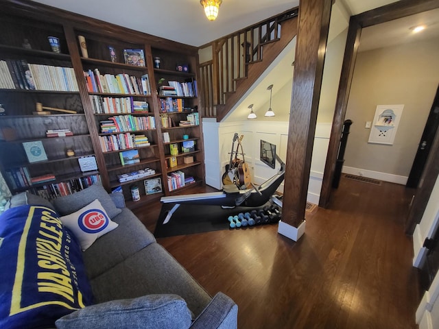 living area featuring baseboards and wood finished floors