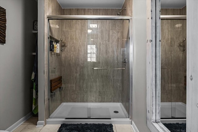 bathroom featuring a stall shower and baseboards