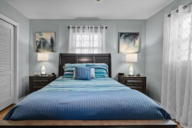 bedroom with baseboards and wood finished floors