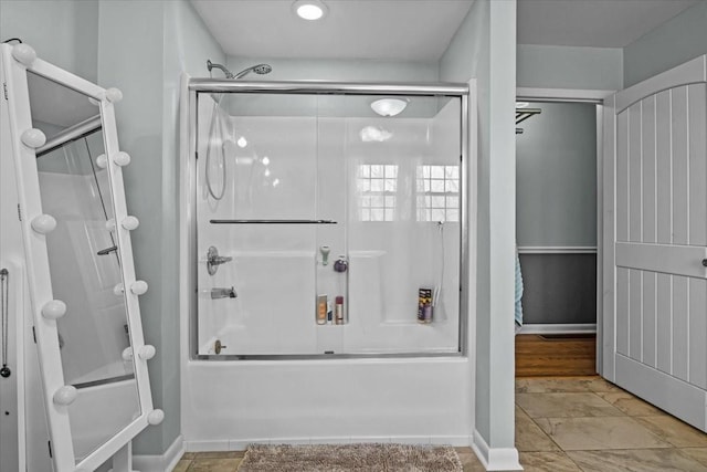 full bath featuring bath / shower combo with glass door