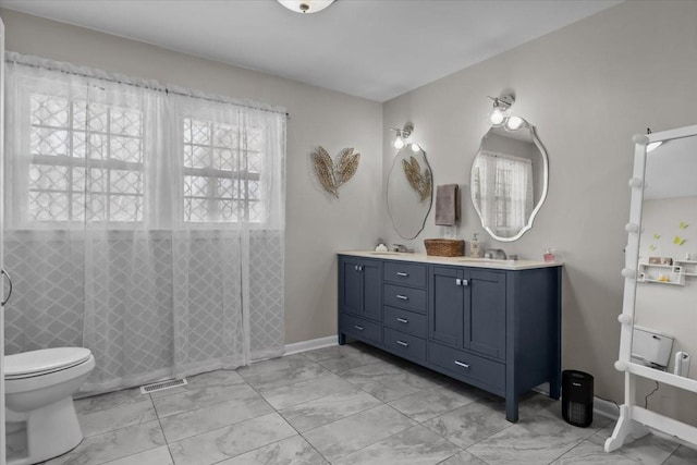 full bathroom featuring double vanity, visible vents, toilet, marble finish floor, and a tile shower