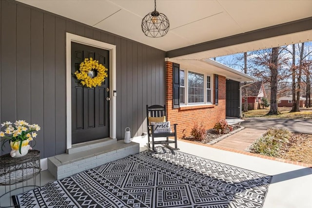 entrance to property featuring brick siding