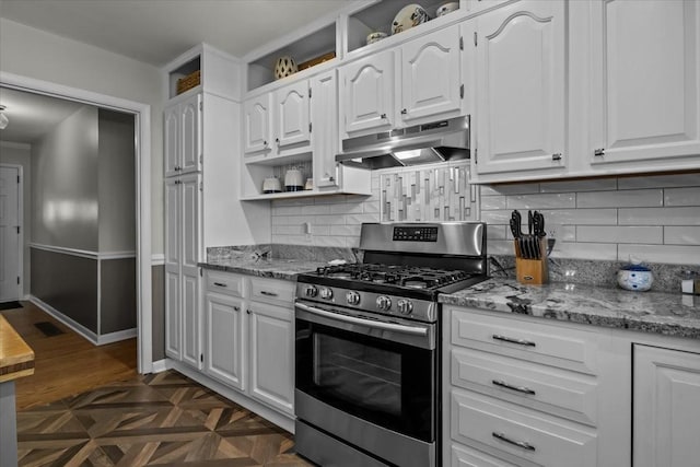 kitchen with light stone counters, tasteful backsplash, white cabinets, stainless steel range with gas stovetop, and under cabinet range hood