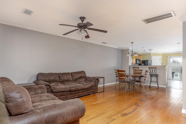 1382 Rural Hill Rd Unit 148, Antioch, TN 37013 - living room featuring baseboards, light wood-style flooring, visible vents, and crown molding