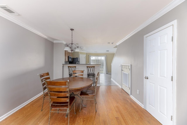 1382 Rural Hill Rd Unit 148, Antioch, TN 37013 - dining area featuring light wood finished floors, visible vents, and ornamental molding