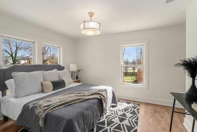bedroom featuring wood finished floors and baseboards