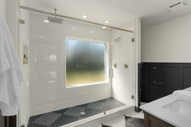 bathroom with a shower stall, visible vents, and a sink