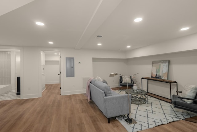 living room featuring wood finished floors, visible vents, baseboards, electric panel, and recessed lighting