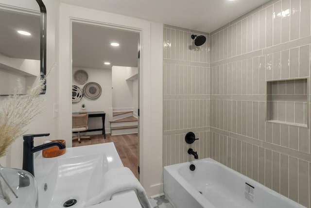 full bath with tub / shower combination, wood finished floors, and recessed lighting