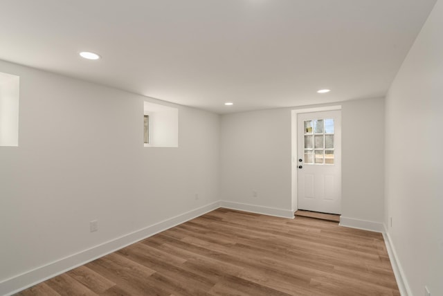 below grade area with recessed lighting, baseboards, and light wood finished floors