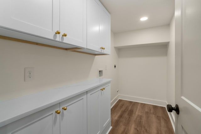 washroom with baseboards, recessed lighting, cabinet space, dark wood-style flooring, and electric dryer hookup