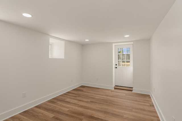 unfurnished room featuring recessed lighting, baseboards, and light wood-style floors