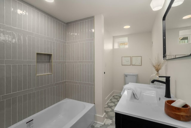 bathroom with a wealth of natural light, vanity, and baseboards