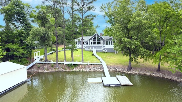 view of dock featuring stairway, a lawn, and a water view