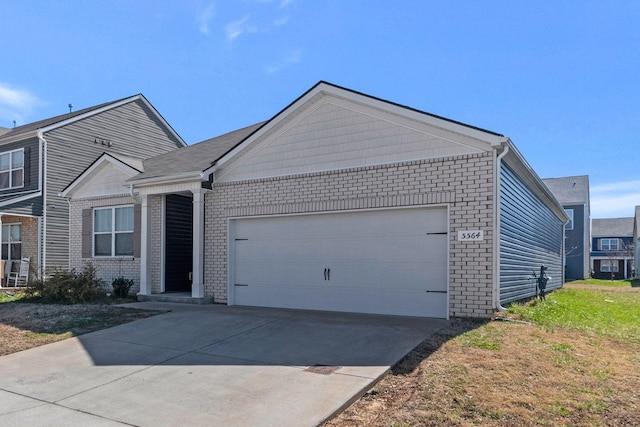 ranch-style home featuring concrete driveway, brick siding, and a garage