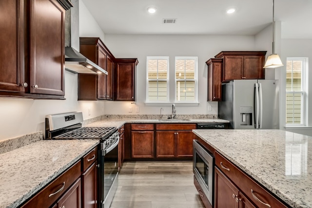 2053 Kirkwall Dr, Nolensville, TN 37135 - kitchen featuring visible vents, wall chimney exhaust hood, stainless steel appliances, light wood-type flooring, and a sink