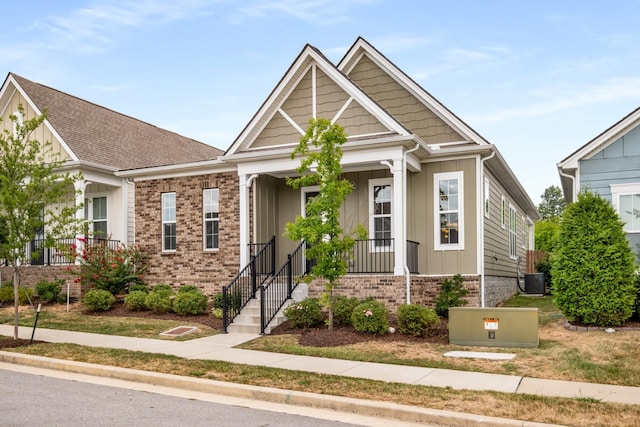 view of front of property featuring brick siding, board and batten siding, and central AC unit