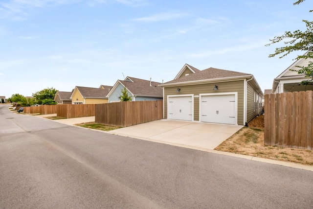 2053 Kirkwall Dr, Nolensville, TN 37135 - view of front of home featuring a shingled roof, a detached garage, and fence
