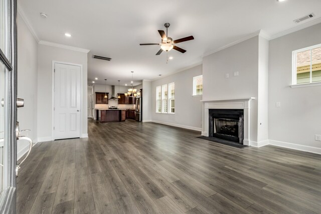 2053 Kirkwall Dr, Nolensville, TN 37135 - unfurnished living room featuring visible vents, dark wood finished floors, a fireplace with flush hearth, ornamental molding, and ceiling fan with notable chandelier