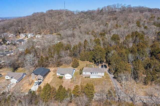 bird's eye view featuring a wooded view