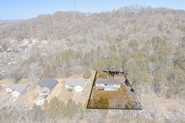 birds eye view of property with a forest view