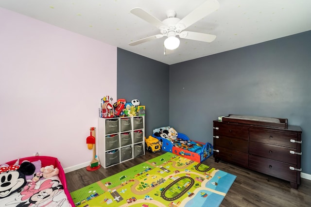 bedroom featuring a ceiling fan, baseboards, and wood finished floors