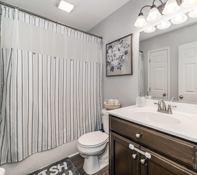 bathroom featuring vanity, curtained shower, and toilet