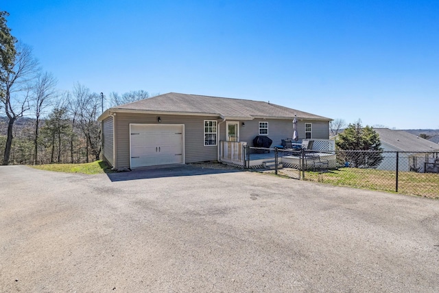 view of front of property featuring a garage and fence