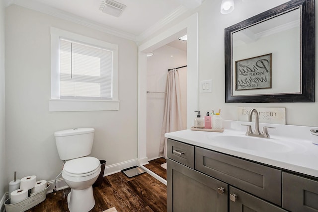 bathroom with crown molding, visible vents, toilet, vanity, and wood finished floors