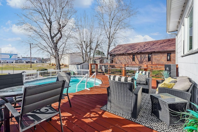 wooden terrace featuring outdoor lounge area, outdoor dining space, fence, a shed, and an outdoor structure