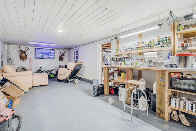 finished basement with wooden ceiling and a workshop area