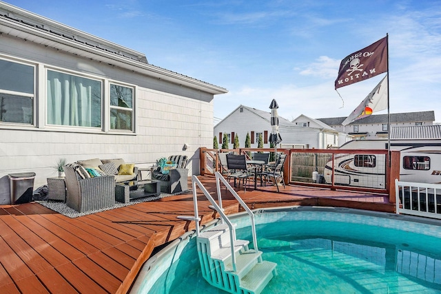 view of pool with outdoor dining space and a deck