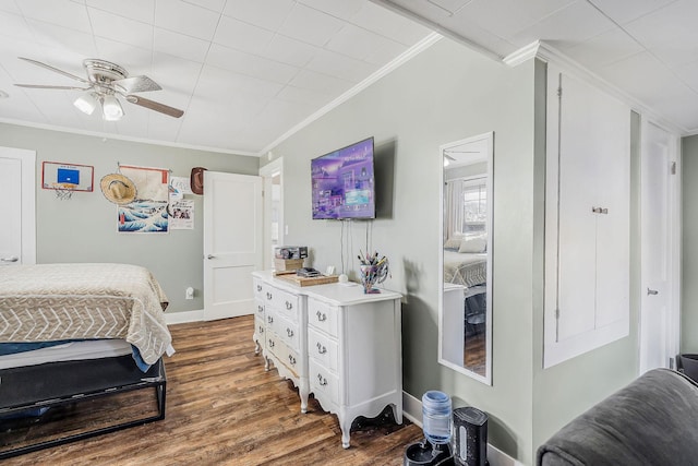 bedroom with baseboards, ornamental molding, and dark wood-style flooring